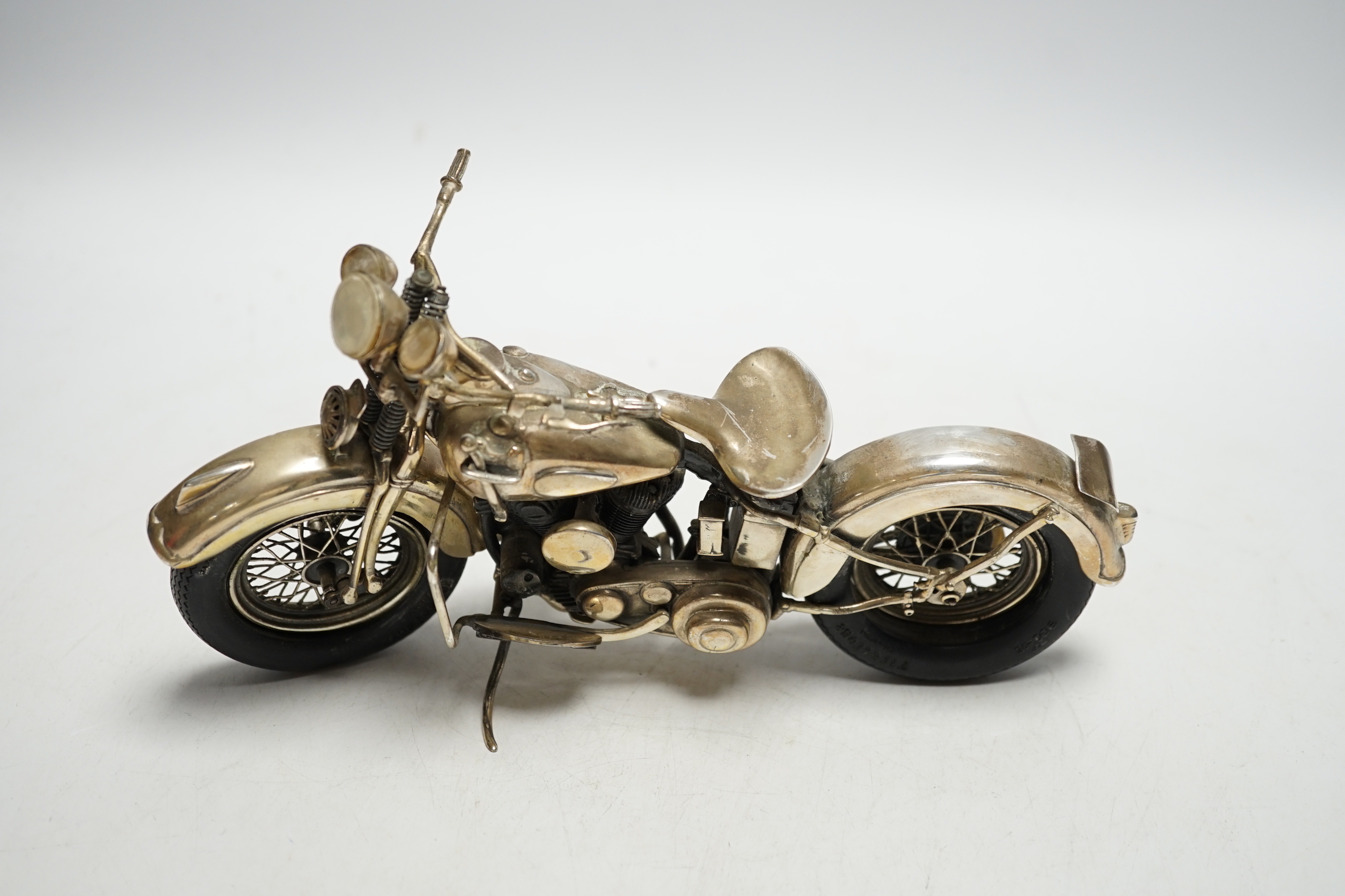 A late 1990's part silver miniature model of a Harley Davidson motor bike, Casa Julia International, London, 1997, length 23.3cm, gross weight 24.9oz.